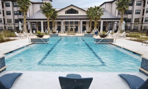 a swimming pool with lounge chairs